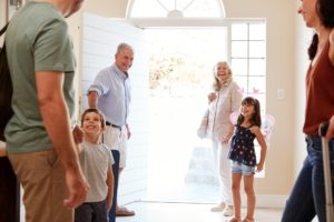 Three generation white family leaving their home to go on holiday, three quarter length, close up