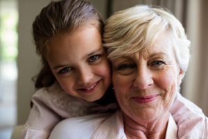 Portrait of granddaughter embracing her grandmother