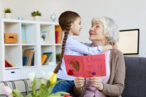 Senior Woman Embracing Cute Girl