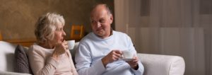 Elderly couple sitting on couch